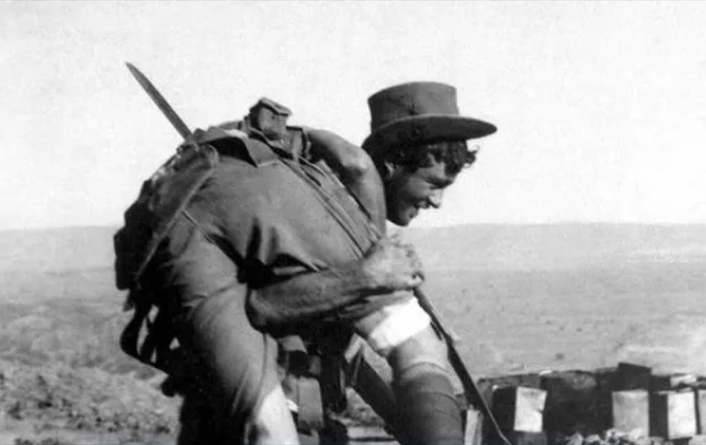 A digger carrying a wounded mate on his shoulders