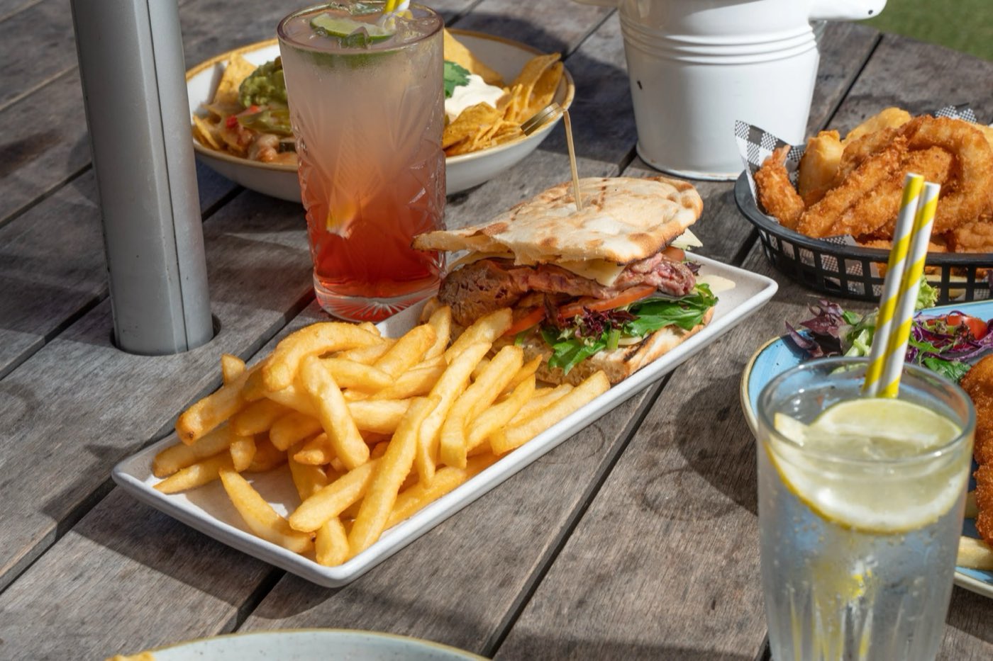 A chicken burger, fries and iced drinks on the terrace