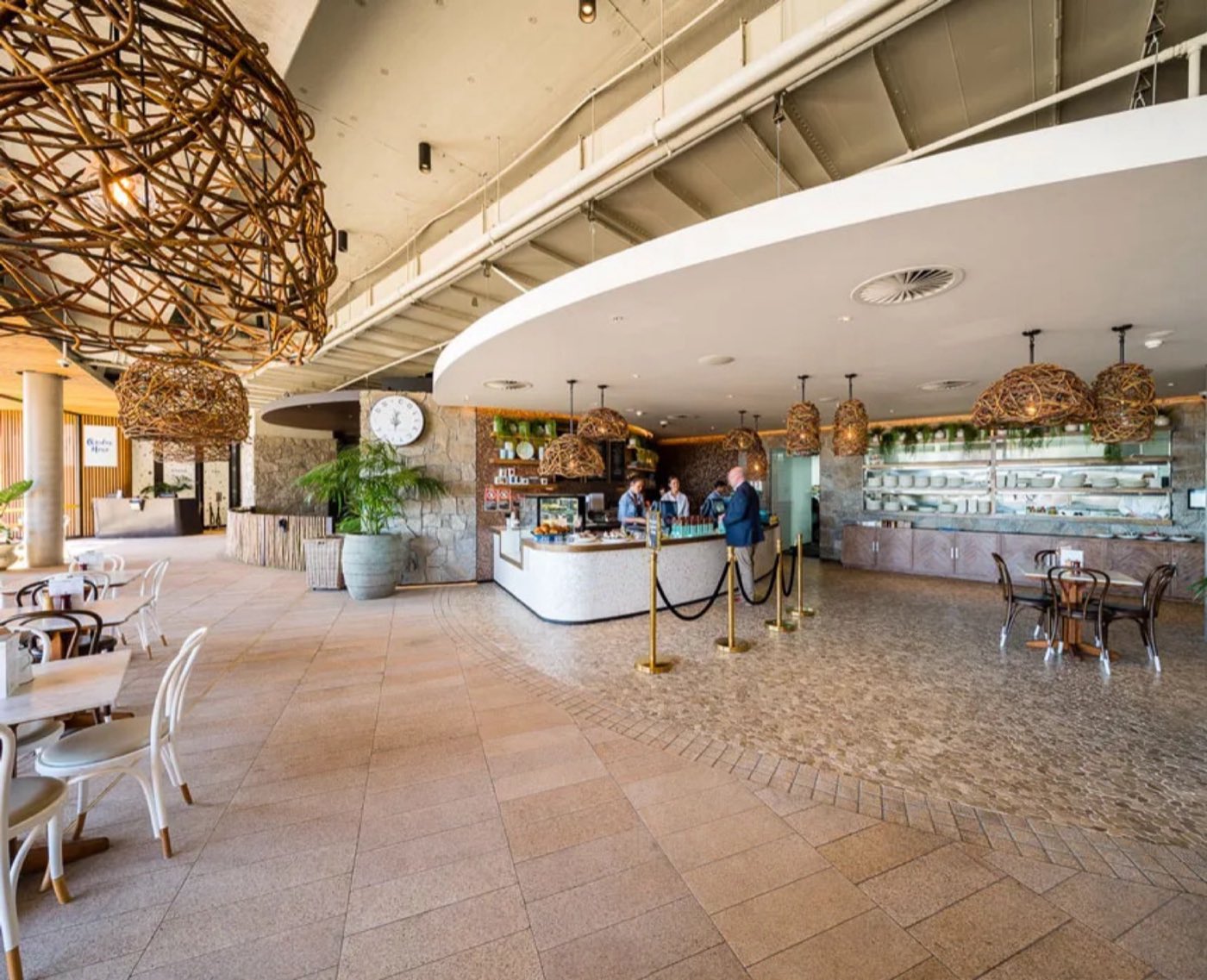 The bright DD Collective café, with its curved counter and woven pendant light