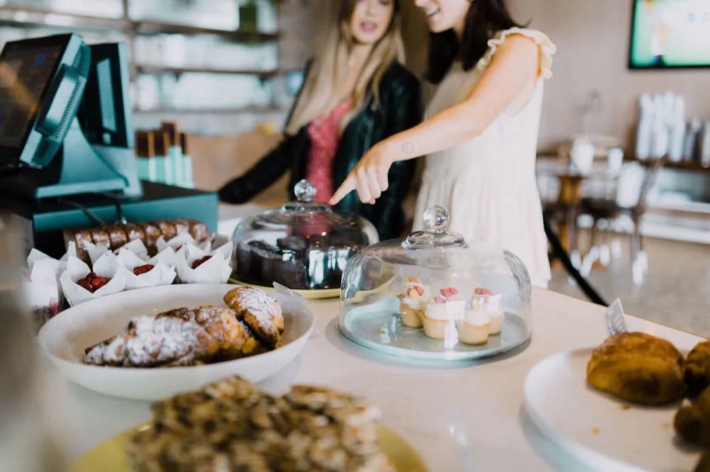 The cake and pastry counter at DD Collective, with staff serving