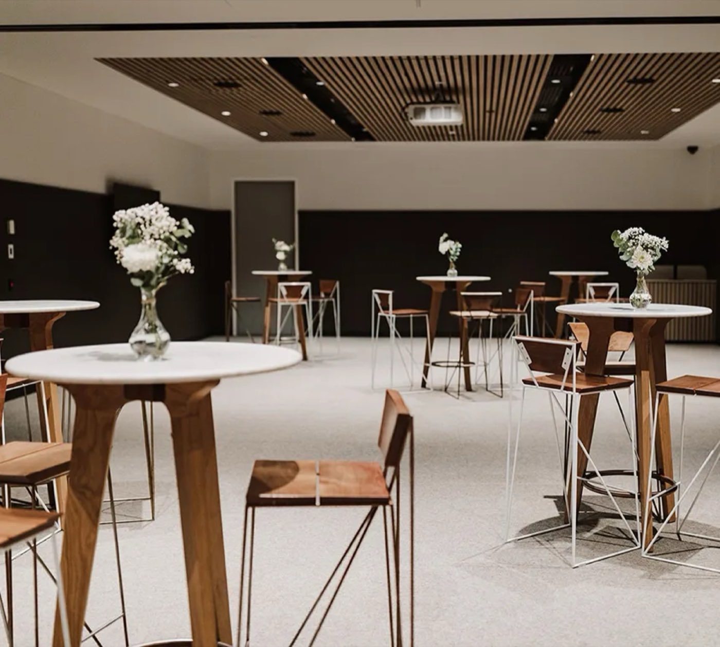 The combined Community Rooms set up cocktail style with high tables