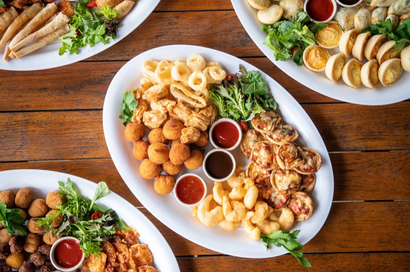 Seafood and finger-food platters on a timber table