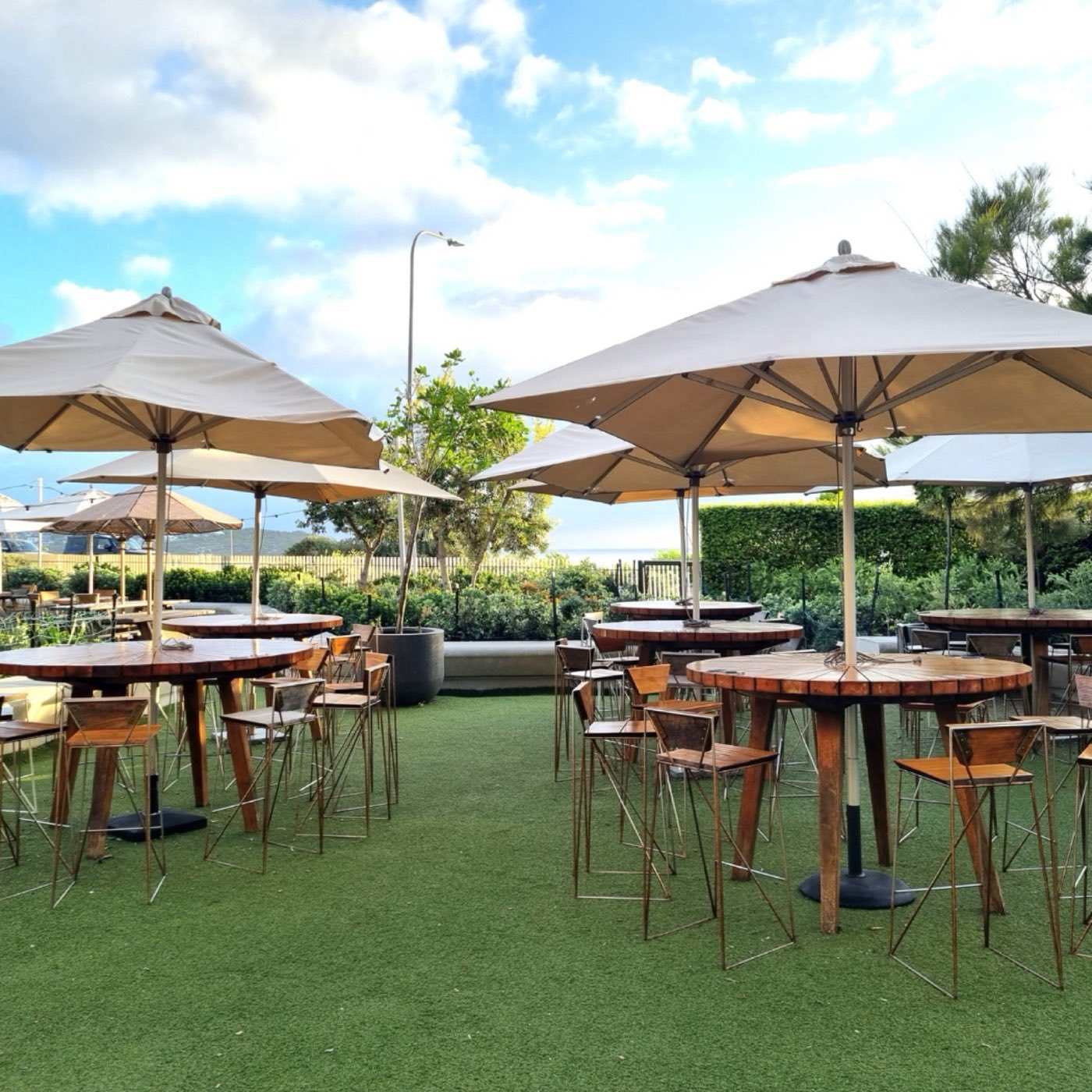 Umbrellas, high tables and lawn on Duke's Terrace
