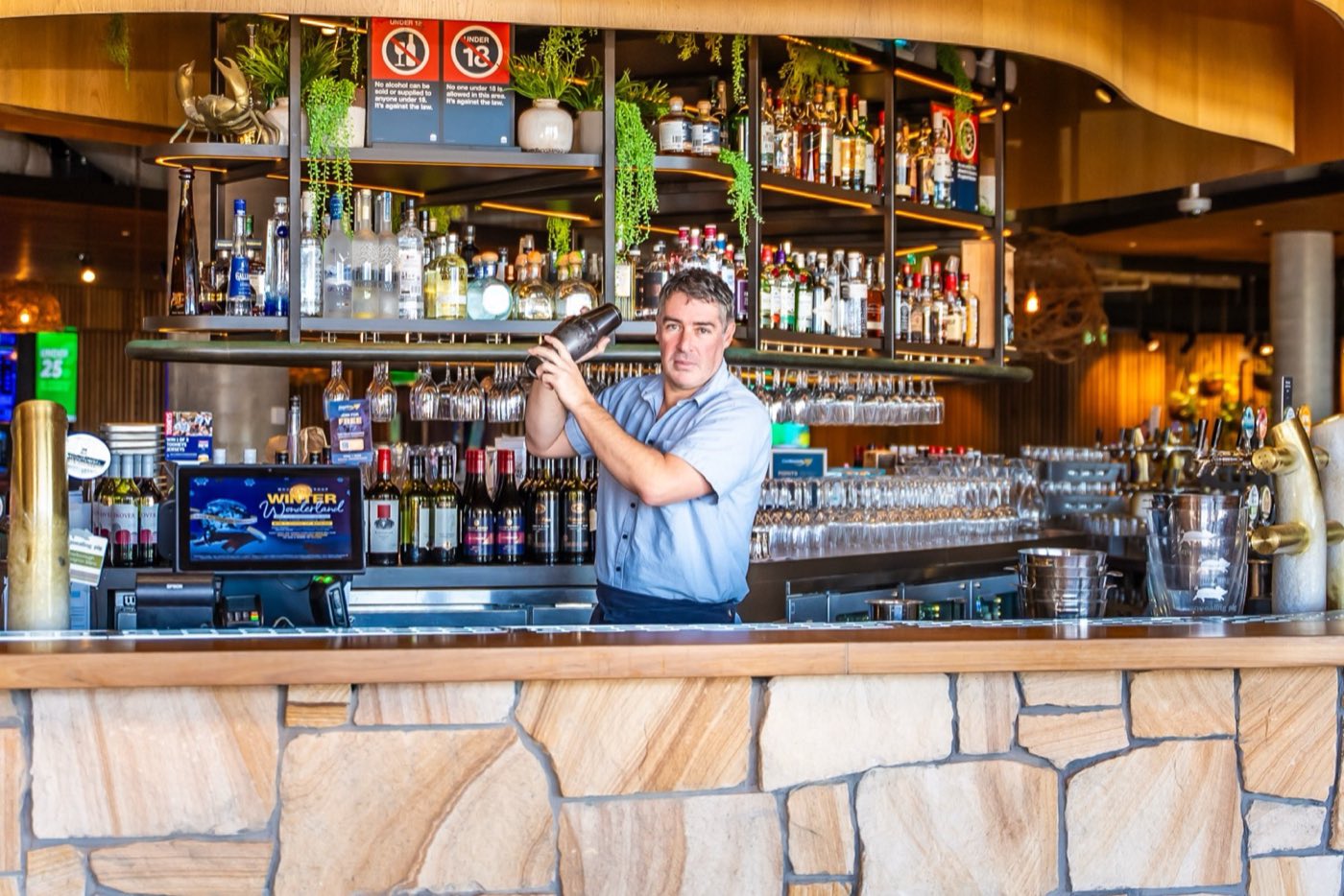 A bartender shaking a cocktail at the Main Bar